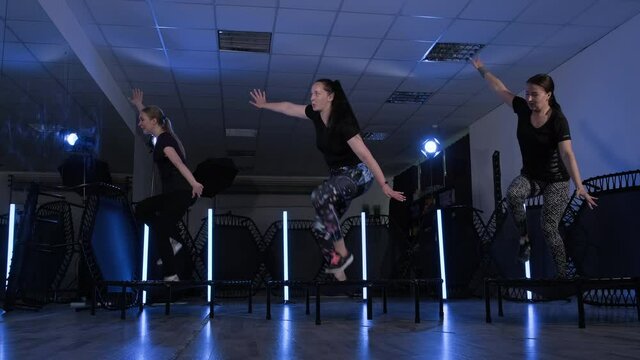 Fitness trampoline training. Women performing exercises on trampolines. Healthy lifestyle. 4K, UHD