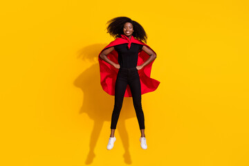 Full length body size photo curly girl jumping high wearing red cover super woman isolated on bright yellow color background - obrazy, fototapety, plakaty