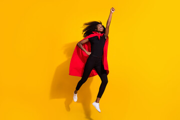 Fototapeta na wymiar Full length photo of hooray super young lady jump wear black cloth cape isolated on yellow color background