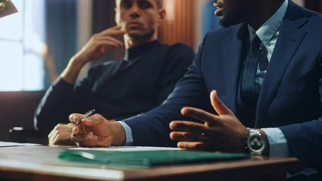 Court of Justice and Law Trial: Male Public Defender Writes Down Arguments for Defence Strategy. African American Attorney Lawyer Fight for Freedom of His Client with Supporting Evidence.