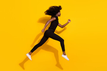 Fototapeta na wymiar Full length body size side profile photo curly girl jumping up running on sale isolated vivid yellow color background