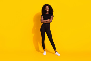 Fototapeta na wymiar Full body photo of charming young happy afro american woman hold hands crossed isolated on yellow color background