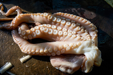 Close-up of tentacles of a fresh raw octopus on a cutting board