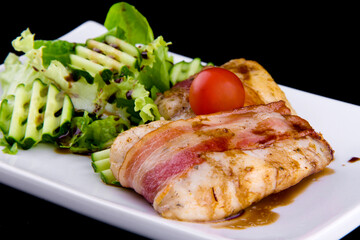 Tender zander in bacon: zander fillet, smoked bacon, pomegranate sauce narsharab, cucumbers, lettuce leaves