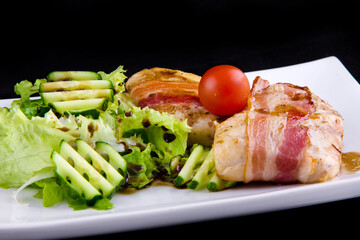 Tender zander in bacon: zander fillet, smoked bacon, pomegranate sauce narsharab, cucumbers, lettuce leaves