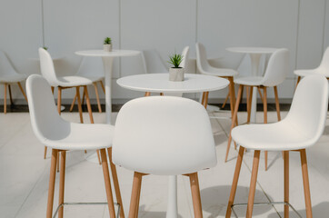 White table and chairs. Cafe interior in light colors.