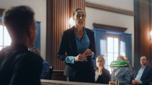 Court of Justice and Law Trial: Female Public Defender Presenting Case, Asking Male Witness in Front of Judge and Jury. Multiethnic Attorney Lawyer Protecting Client Against Crime, Injustice.