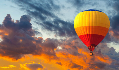 Beautiful hot air balloons flying against a dramatic sunset sky.