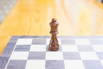 Perspective view and selective focus with copy space of only king in chess game on checkerboard...