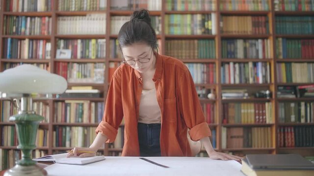 Frustrated architect student comparing measures on drawing with notes, mistakes