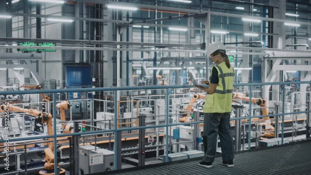 Poster female car factory engineer in high visibility vest using laptop computer. automotive industrial man