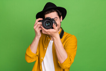 Photo of young handsome professional photographer take picture you camera isolated on green color background - obrazy, fototapety, plakaty