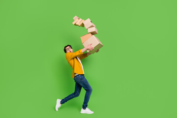 Full size photo of young amazed shocked guy hold carton boxes falling moving relocation isolated on...