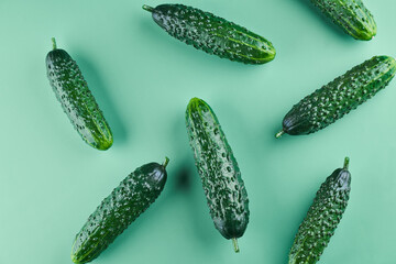 Set of fresh whole cucumbers on a green background, food pattern. Garden cucumber wallpaper backdrop design