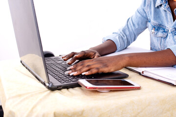 close-up of a young student working at the laptop.