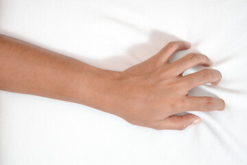 Young woman in bed clutching tightly her hand Bed pulling and grab white bed sheet.