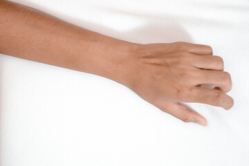 Young woman in bed clutching tightly her hand Bed pulling and grab white bed sheet.