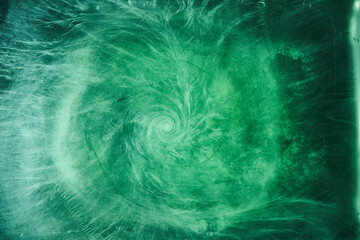 Obraz na płótnie Canvas Abstract green color background. Swirling vibrant hookah smoke, underwater emerald ocean, dynamic paint in water