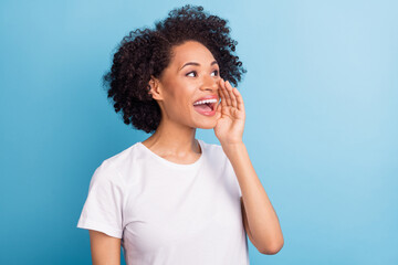 Portrait of attractive cheerful girl saying news ad copy space isolated over bright blue color background