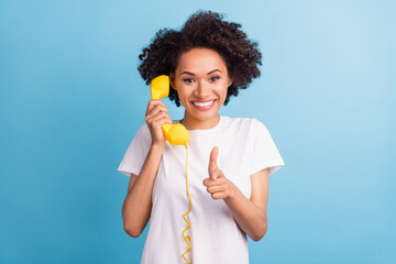 Portrait of attractive brunette cheerful girl calling pointing at you isolated over bright blue color background