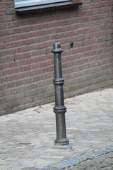 Metal bollard on a sidewalk