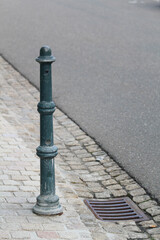 Metal bollard on a sidewalk