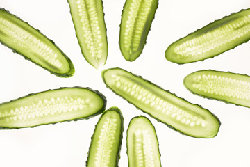 Cucumber green slices pattern isolated on white background. Creative cucumbers wallpaper, food backdrop design