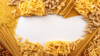 Frame from Assorted varieties of pasta wallpaper. Mix macaroni, spaghetti on white background with...