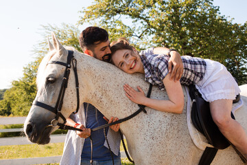 The young couple are having fun time with horse