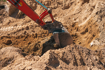 Excavator shovel digging on dirt