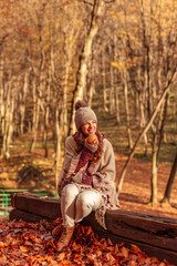 Woman eating an apple on a sunny autumn day