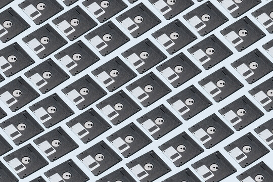 Pattern of retro floppy disks on blue table