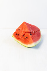 piece of watermelon on white wooden table