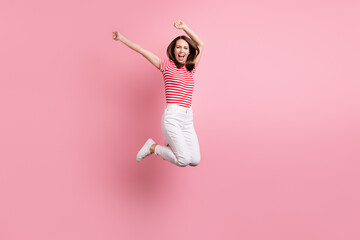 Full length photo of young girl happy positive smile have fun jump up isolated over pink color...