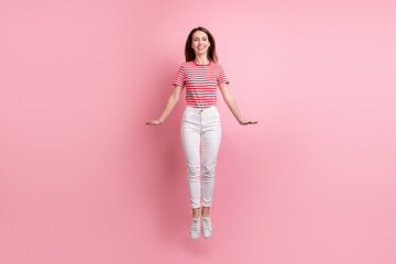 Full body photo of young girl happy positive smile active have fun jump isolated over pink color background