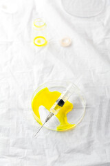 syringe into a Petri dish with reagent or drug