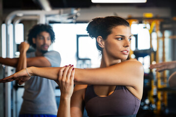 Happy diverse people exercise together in gym to stay healthy
