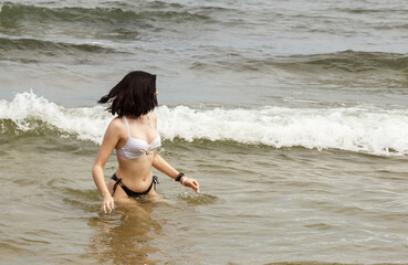 young woman swims in the sea