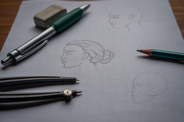 A beginner's drawing of a woman's face. On a wooden table.