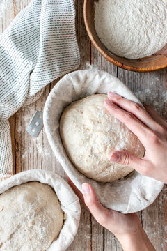 woman hands holding Loaf of sourdough bread