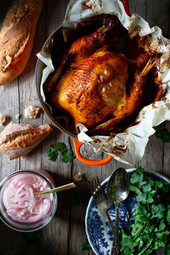 Roasted chicken with variety products on wooden table