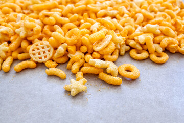 Detail of a snack based on flavored cheese puff, with corn flour and hydrogenated fats.