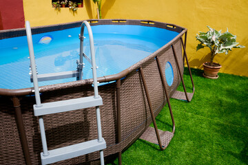 A plastic pool mounted in the courtyard of a Mediterranean manor house.