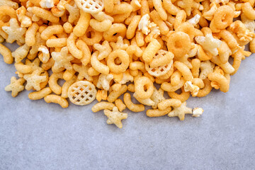 unhealthy puff food cheese in different shapes and orange color.