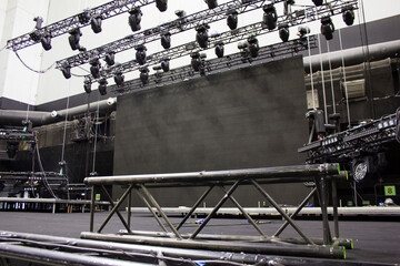 Black steel rigging truss for lifting. Installation of professional sound, light, video and stage equipment for a concert. - obrazy, fototapety, plakaty