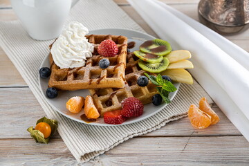 belgium waffles with ice cream, caramel sauce and fresh berries