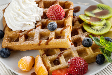 belgium waffles with ice cream, caramel sauce and fresh berries