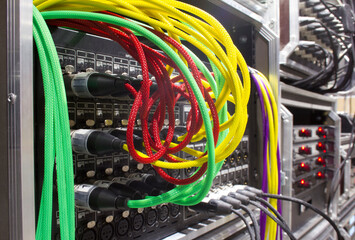 Microphone sound cables connected to the audio signal console on the stage. Plugged XLR cables....