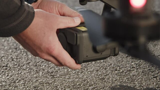 preparing a big drone RTK for flying over a roof to measure its size, changing Batteries, unfold the wings, camera 