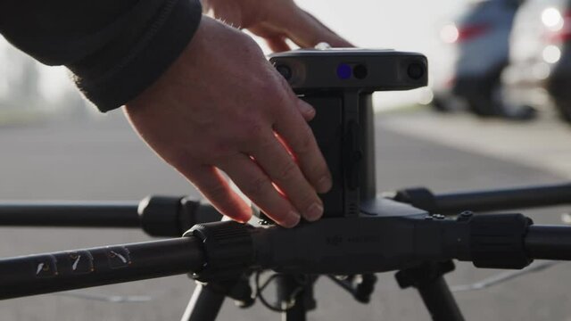 preparing a big drone RTK for flying over a roof to measure its size, changing Batteries, unfold the wings, camera 